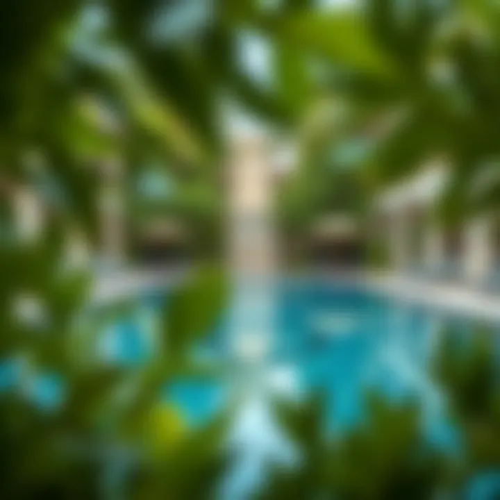 Luxurious pool area surrounded by lush greenery at Balqis Residences